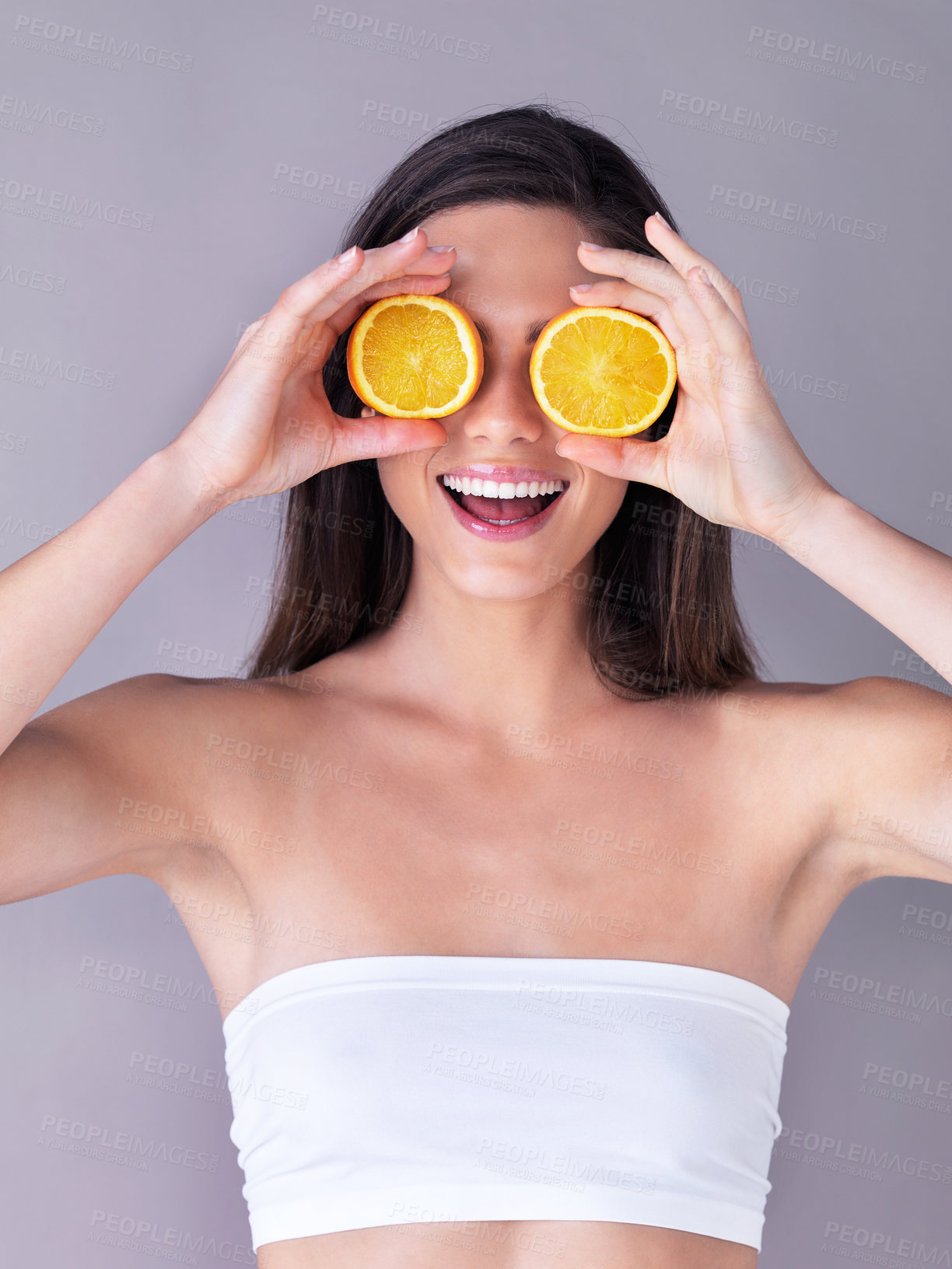 Buy stock photo Orange, skincare and woman in studio with beauty, organic and vitamin c routine for glow. Natural, happy and person with citrus fruit for dermatology treatment for face brightening by gray background