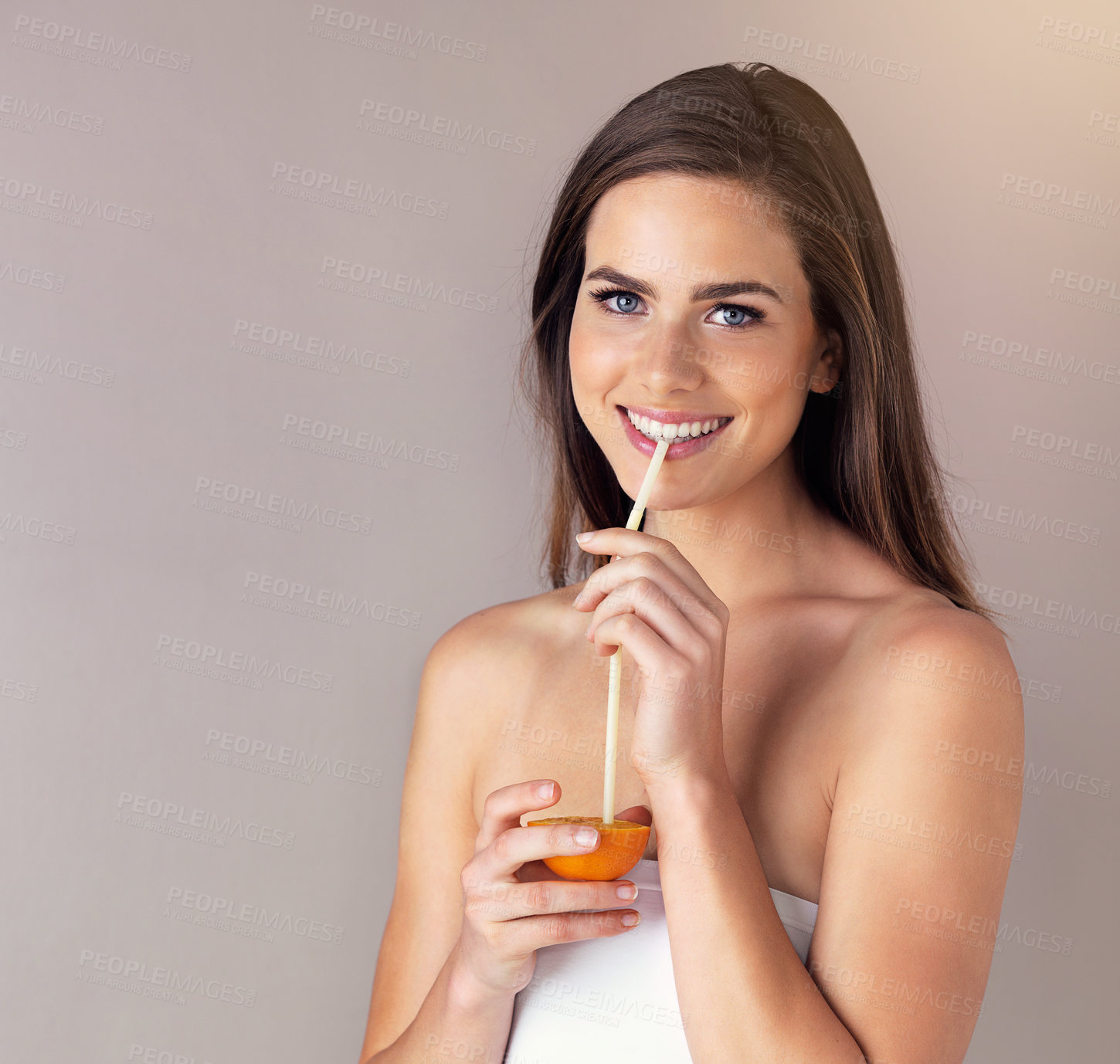 Buy stock photo Woman, portrait and drinking orange fruit in studio, juice and nutrition on gray background. Female person, mockup space and straw for vitamin c diet or detox, organic liquid and fiber antioxidant