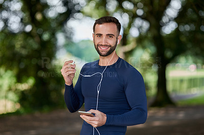 Buy stock photo Runner, man and smartphone with music in portrait at park, smile and exercise with audio streaming app. Person, happy and phone for online subscription to listen with earphones at training in Seattle