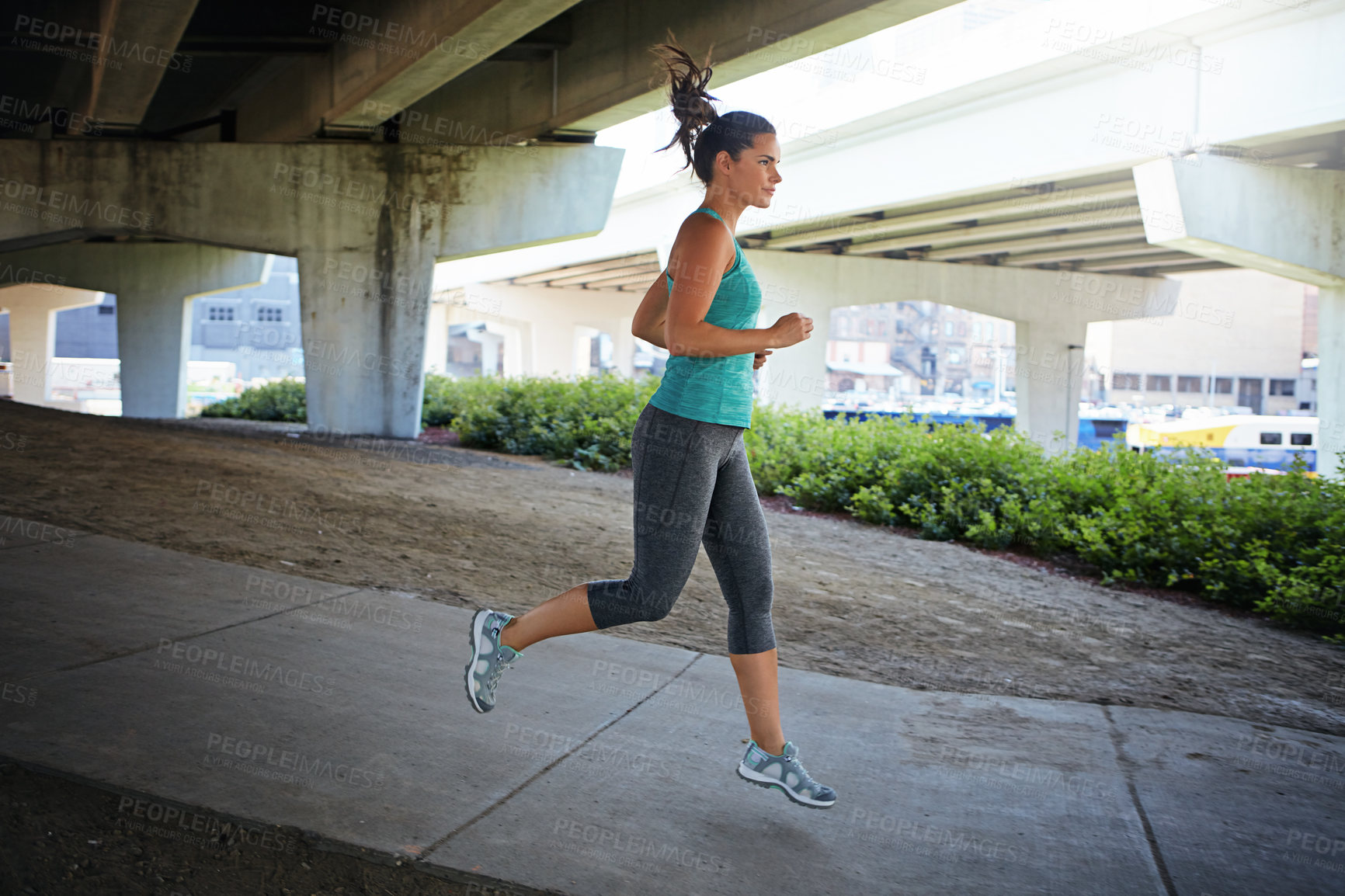 Buy stock photo Shot of an attractive young female runner exercising outdoors