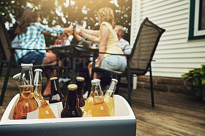 Buy stock photo Outside, case and alcohol on weekend with friends for beer, cider and spirits on porch or backyard. Celebration, social and dinner party for reunion, meal and summer in America with drinks for cheers