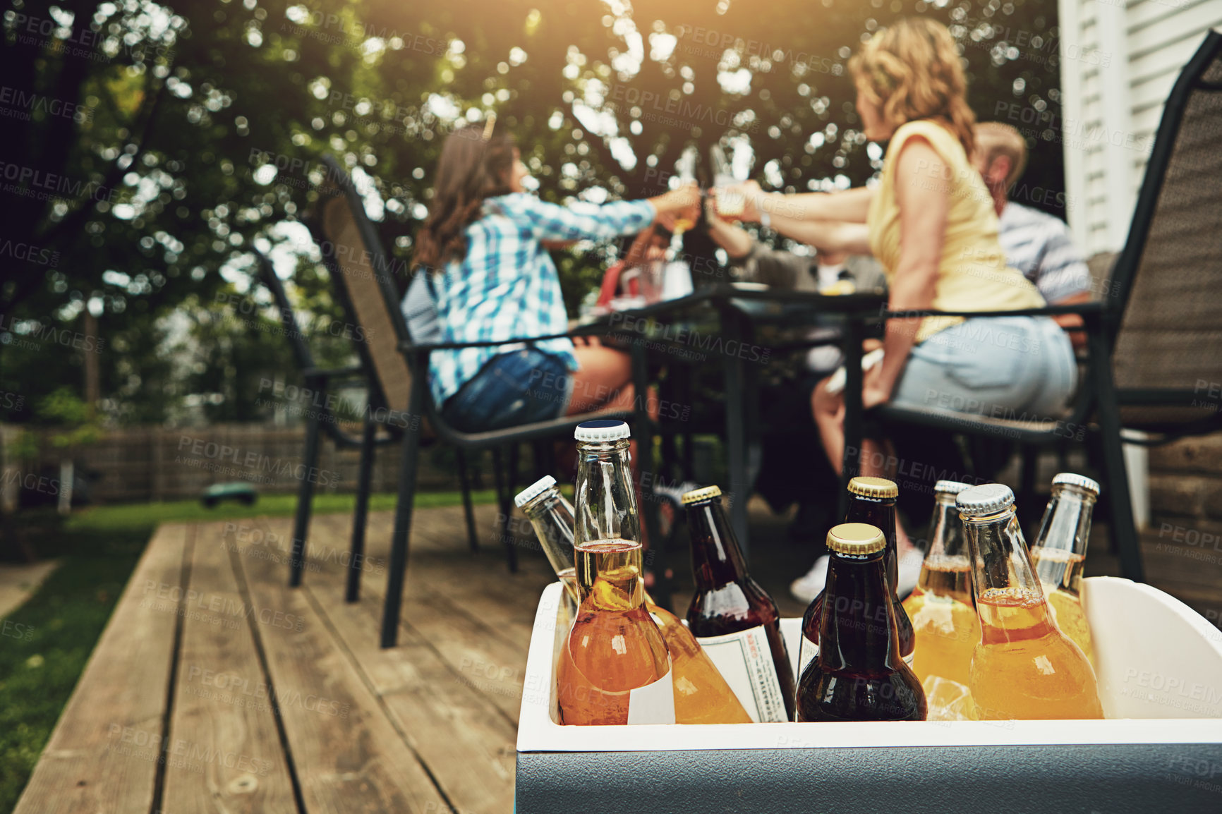 Buy stock photo Weekend, outside and case with alcohol for friends with beer, cider and spirits on porch or backyard. Social, relax and dinner party with reunion, people and summer in Germany with drink for cheers.