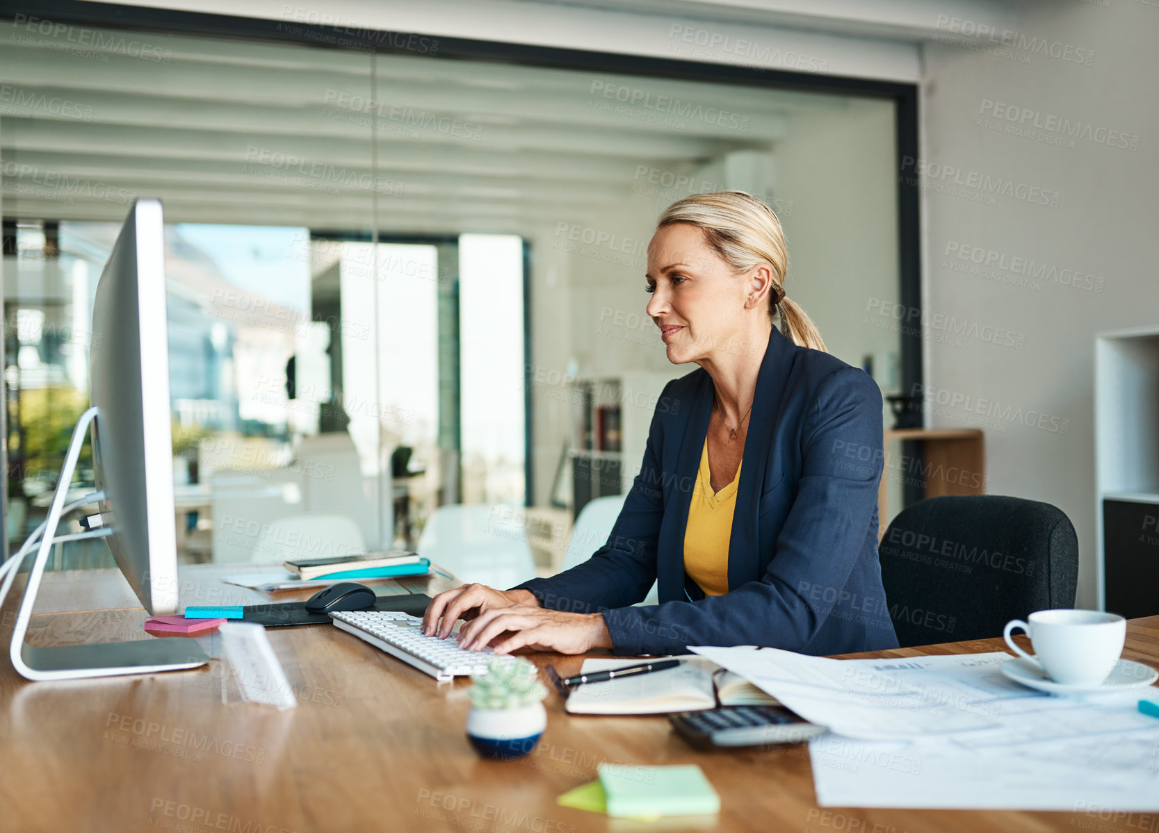 Buy stock photo Cropped shot of a mature businesswoman working on her computer in a corporate office