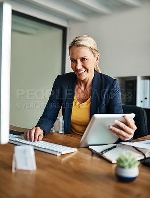 Buy stock photo Cropped portrait of a mature businesswoman working on a tablet in her corporate office
