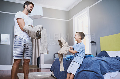 Buy stock photo Cropped shot of a handsome young man and his son getting dressed in the morning