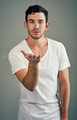 Buy stock photo Studio shot of a casual young man posing against a grey background