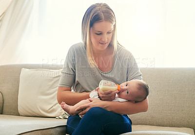 Buy stock photo Mother, milk and feeding baby of sofa in living room for growth development, nutrition or digestive health. Bottle, formula and woman with infant child for drinking, wellness or bonding in home