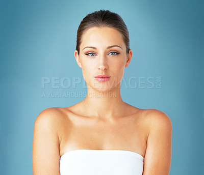 Buy stock photo Woman, glow and portrait in studio for skincare with natural makeup, wellness and facial beauty. Female person, face and dermatology for collagen cosmetics, shine and skin health by blue background