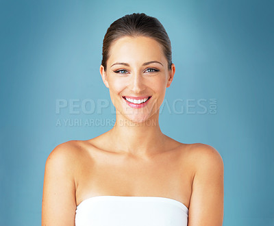 Buy stock photo Woman, portrait and beauty care in studio, aesthetic and confident feminine on blue background. Female person, facial treatment and foundation glow for smooth skin, cosmetics and clean dermatology