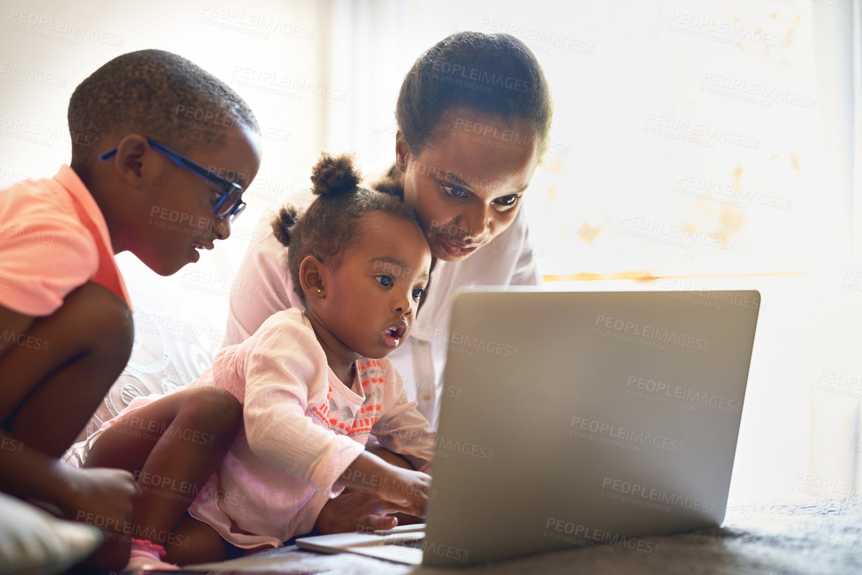 Buy stock photo Cropped shot of an affectionate young family using a laptop together at home