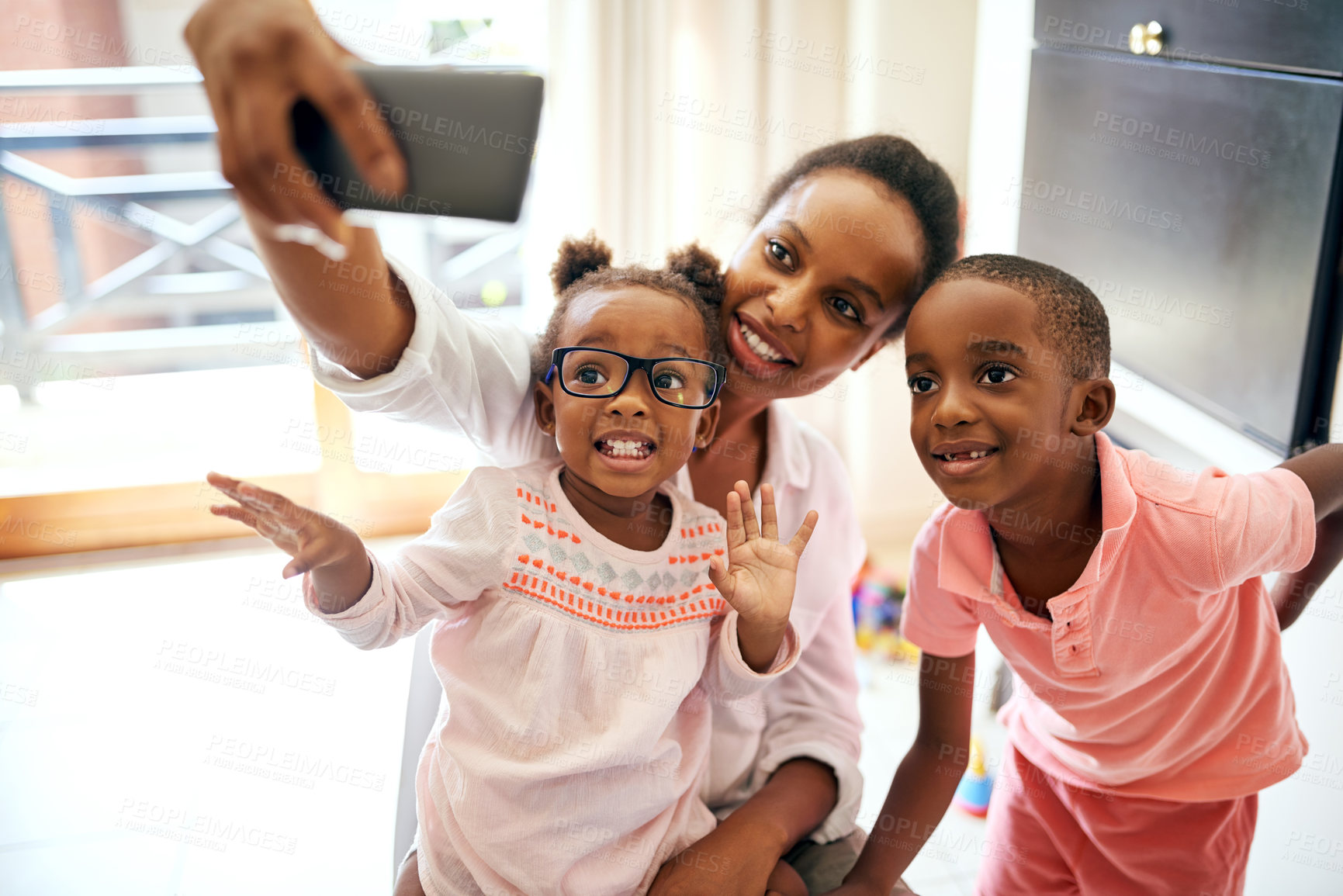 Buy stock photo Cropped shot of an affectionate young family taking selfies at home