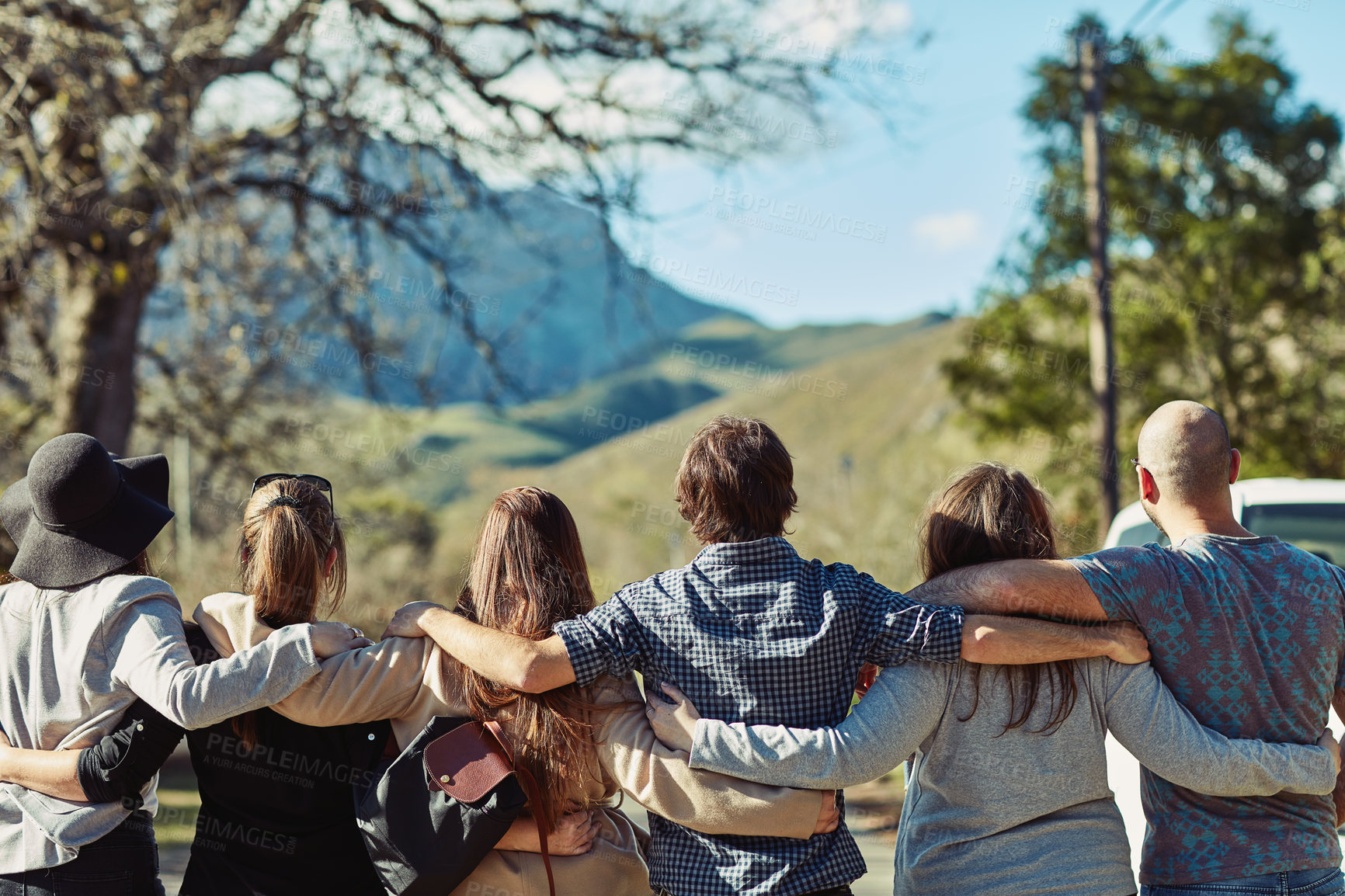 Buy stock photo Rearview shot of a group of friends standing together