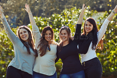 Buy stock photo Cropped shot of a group of friends enjoying themselves outdoors