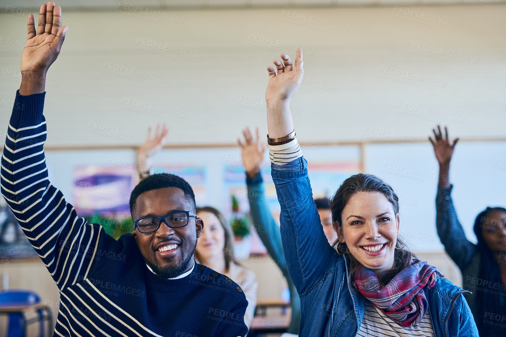 Buy stock photo Students, man and woman with hand raised in portrait, classroom and happy with question at university. People, smile and excited for learning, education and answer for quiz with diversity in Canada