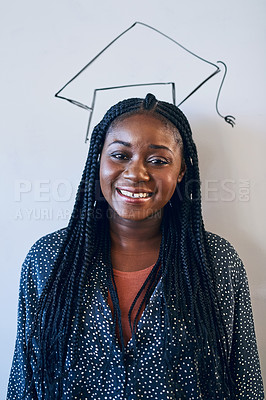 Buy stock photo Cropped shot of a young university student standing against a whiteboard with a graduation cap drawn on it