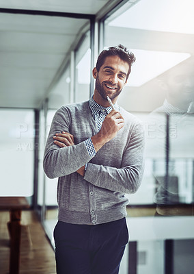 Buy stock photo Cropped portrait of a handsome young businessman looking thoughtful while standing in the office