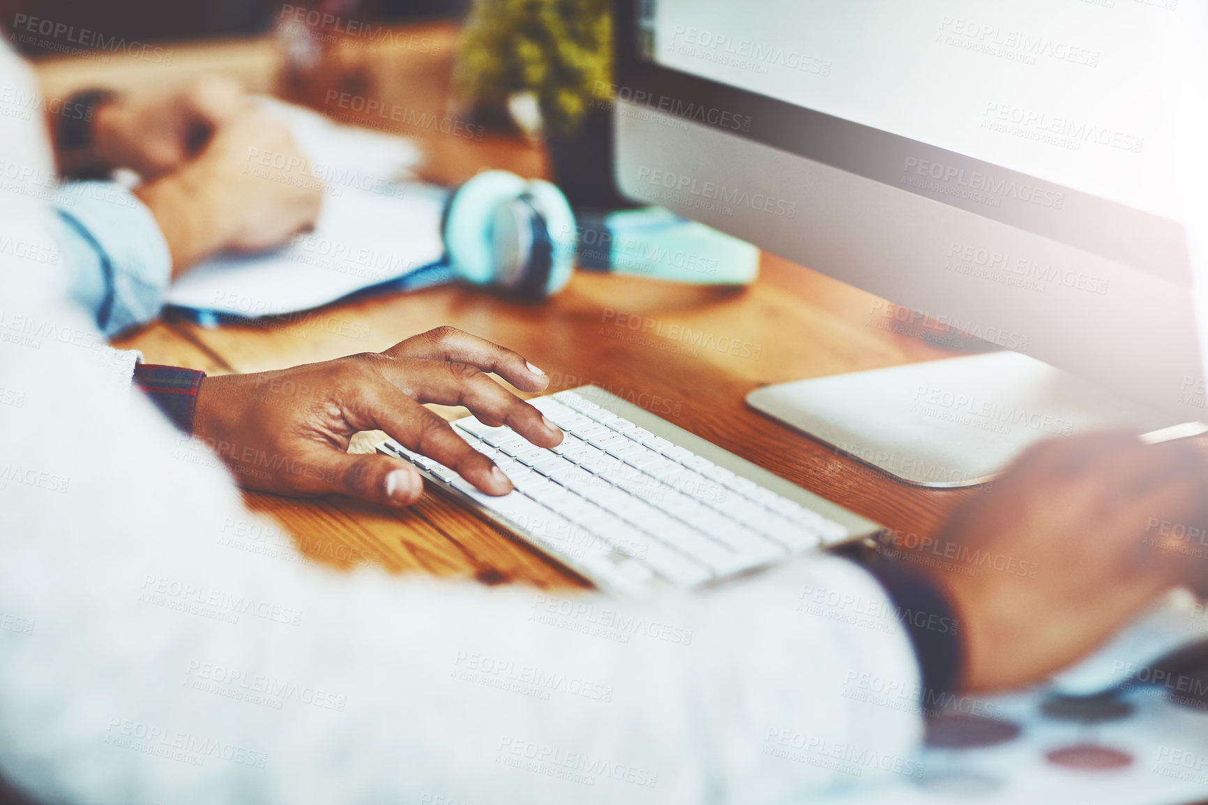 Buy stock photo Closeup shot of an unrecognizable businessman working on a computer in an office