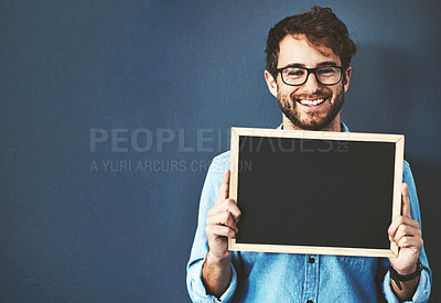 Buy stock photo Smile, glasses and man with chalkboard for mockup space with marketing, promotion or advertising. Happy, portrait and male teacher from Canada with sign for education isolated by studio background.