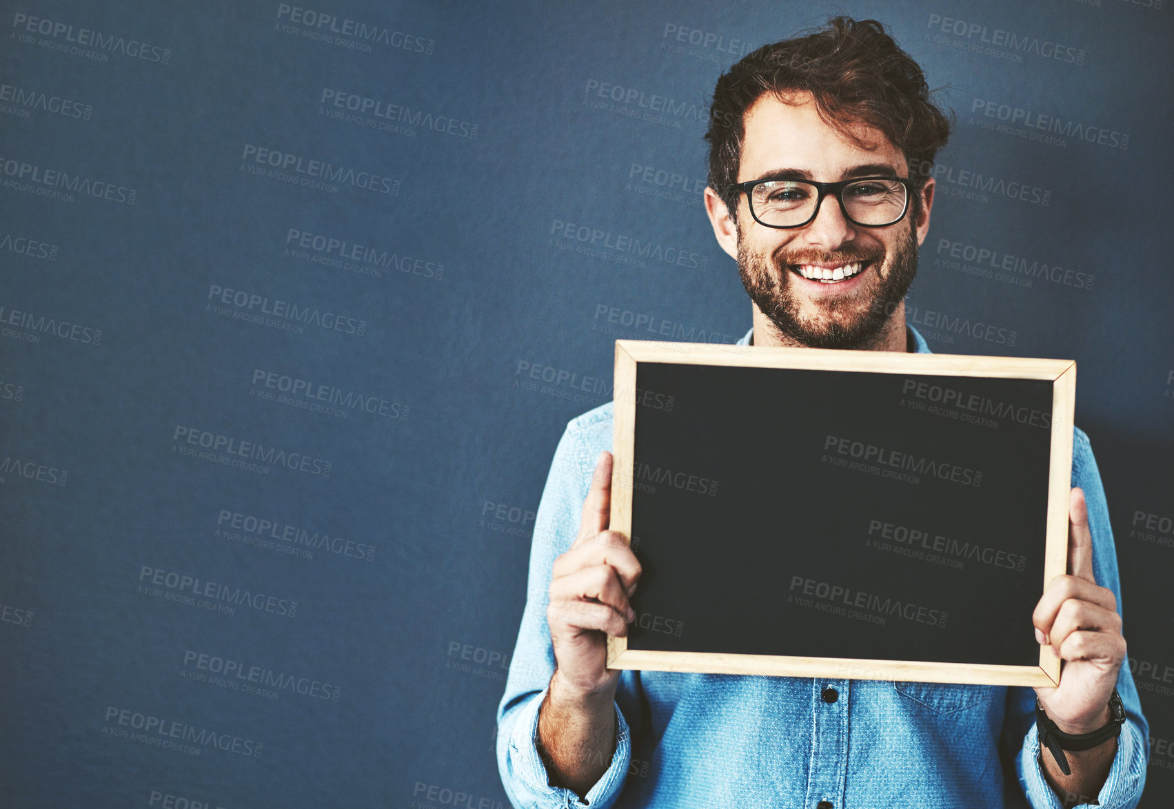 Buy stock photo Smile, glasses and man with chalkboard for mockup space with marketing, promotion or advertising. Happy, portrait and male teacher from Canada with sign for education isolated by studio background.