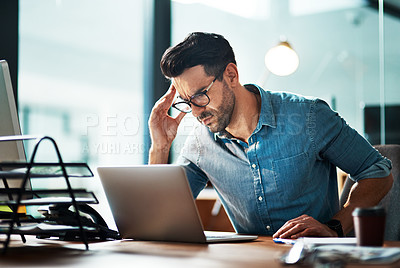 Buy stock photo Businessman suffering from a headache or migraine due to stress caused by work deadlines. Professional holding head in pain feeling anxious, overwhelmed and stressed while busy on his computer desk