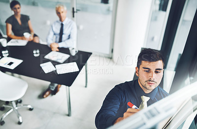 Buy stock photo High angle shot of a group of corporate businesspeople meeting in the boardroom