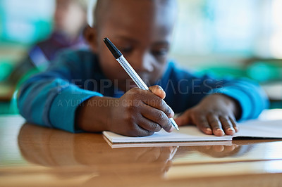 Buy stock photo Shot of an elementary school boy working in class