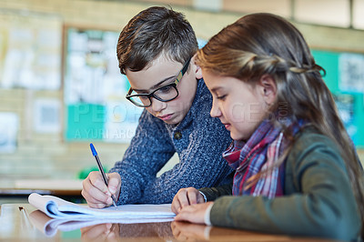 Buy stock photo Shot of two elementary school kids working together in class