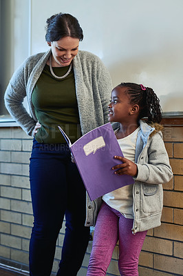 Buy stock photo Girl, book and presentation in classroom with teacher, smile and together for development at academy. Child, oral and speech with notebook, education and learning for future with progress at school