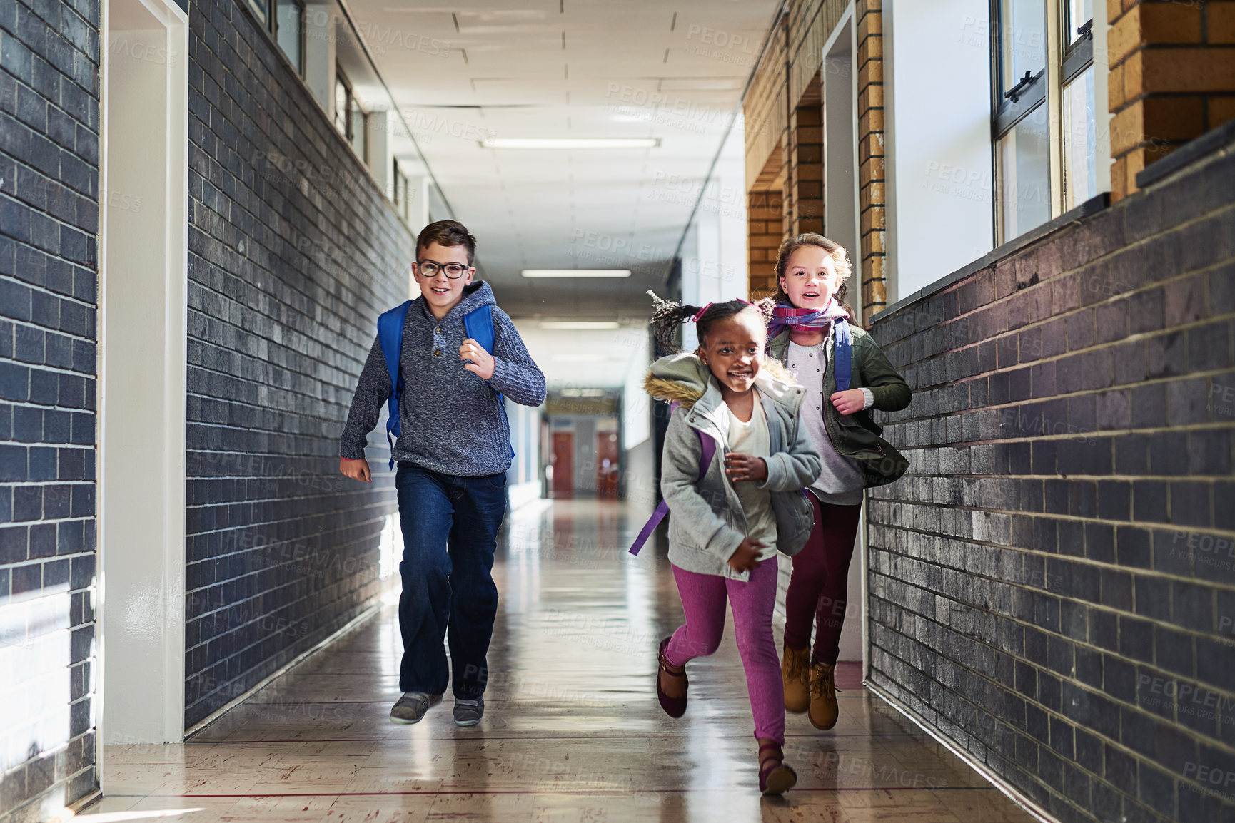 Buy stock photo Education, school kids and students running in corridor for recess, learning break and energy with backpack. Learners, friends and race in hallway for fun activity, challenge and child development