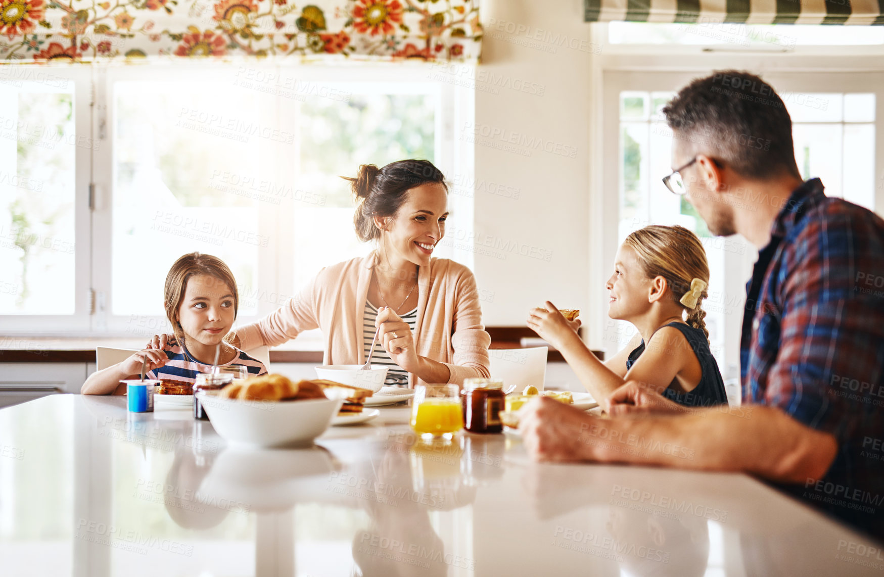 Buy stock photo Cropped shot of a family enjoying breakfast together