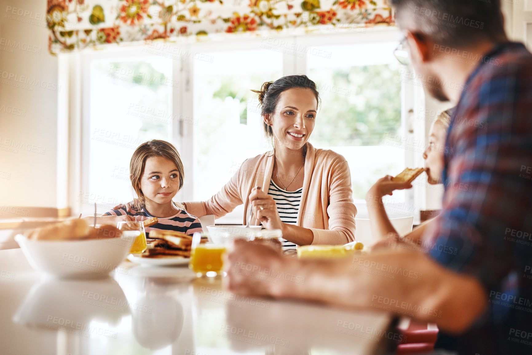 Buy stock photo Cropped shot of a family enjoying breakfast together