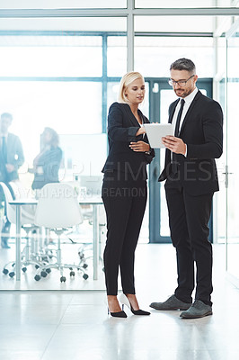 Buy stock photo Full length shot of two corporate businesspeople talking before their meeting in the boardroom