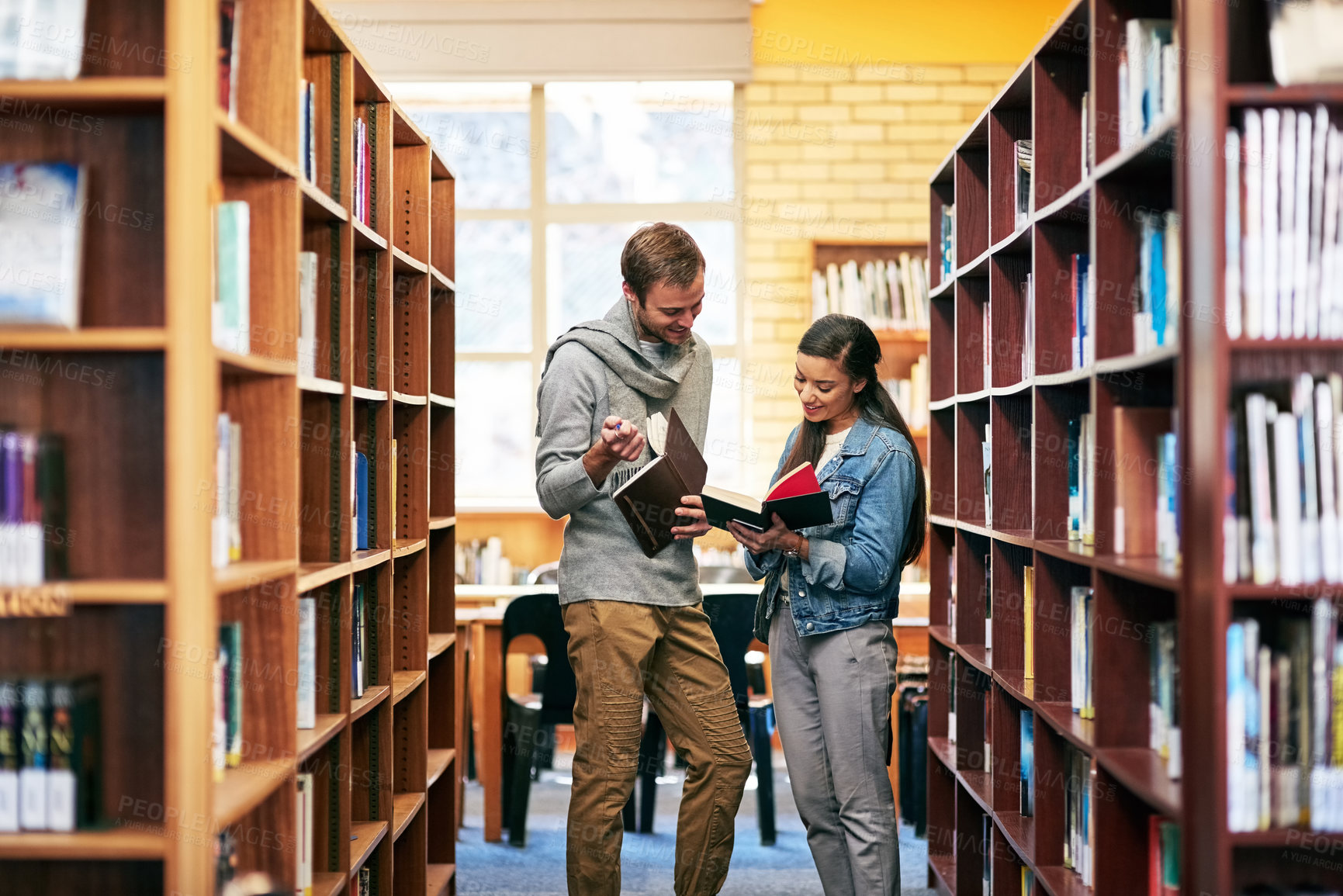 Buy stock photo People, students and library speak with books, happy and campus for learning or university education. Discussion, academic scholarship and collaboration, exam preparation and college thesis
