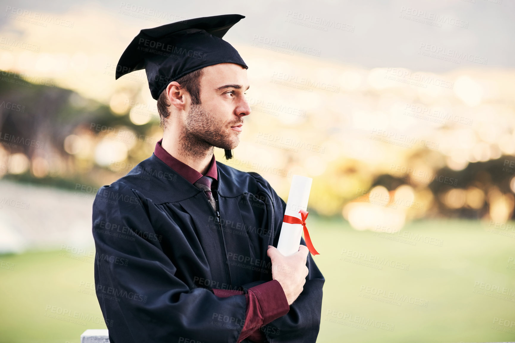 Buy stock photo Graduation, student and man with certificate outdoor for diploma ceremony, achievement and thinking of future. College graduate, bokeh and scholarship success with academic milestone, degree or event
