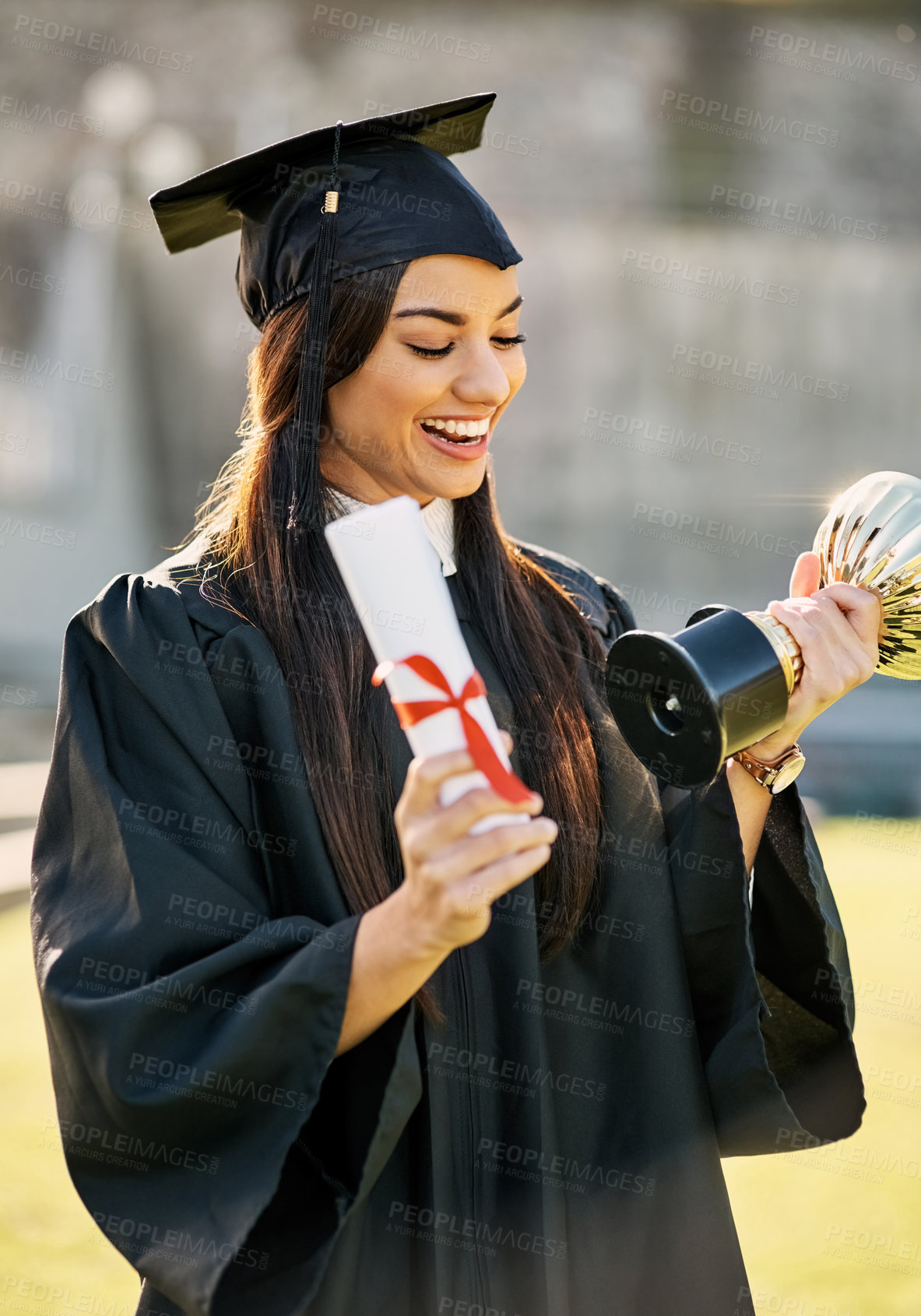 Buy stock photo Graduation, student or woman with trophy or diploma outdoor for degree ceremony, achievement and excited. College graduate, person and scholarship success with academic milestone or certificate event