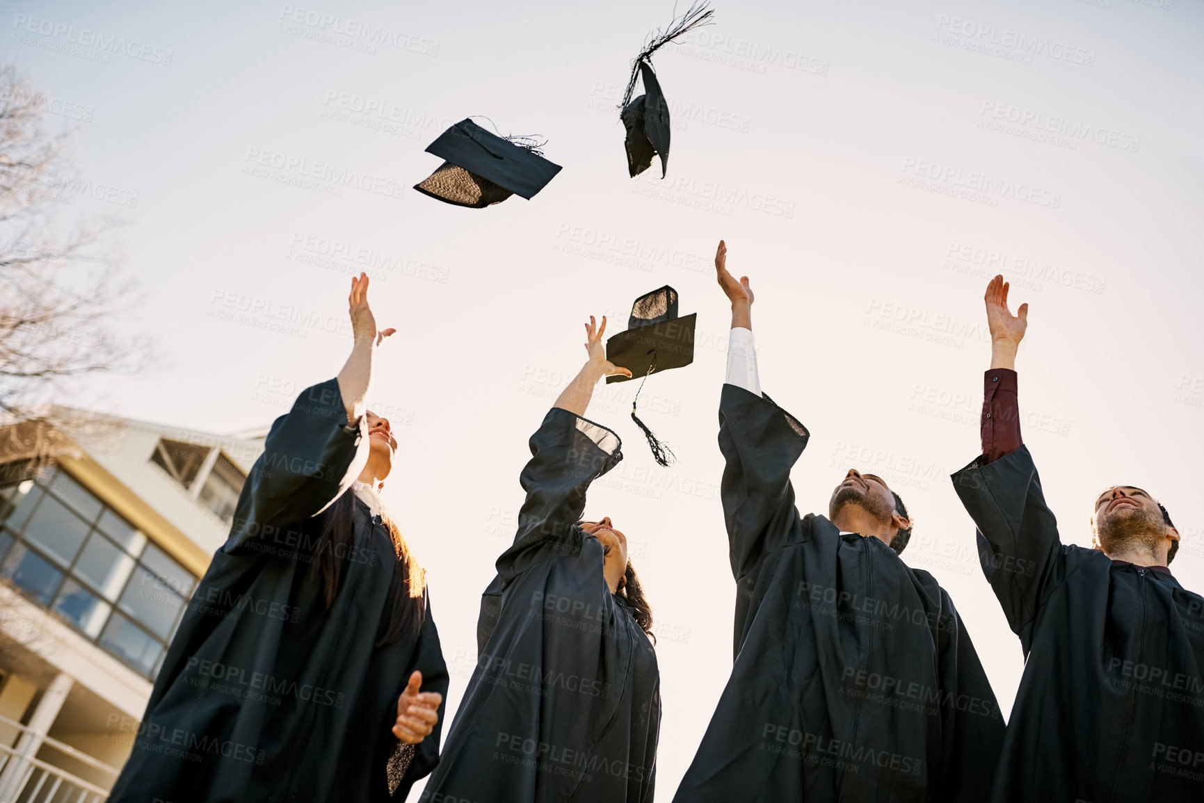 Buy stock photo Education, air and group with hats, graduation and proud of certificate, event and celebration. Outdoor, students and ceremony for people, knowledge and achievement in university and success with cap