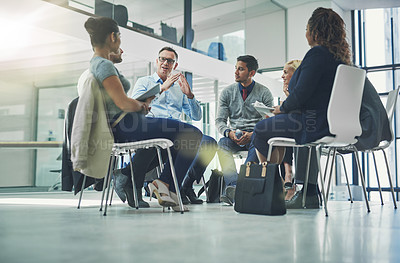 Buy stock photo Teamwork, collaboration and strategy planning of business team working together indoors. Modern office workers talking and sitting in a group meeting. Colleagues work and talk about a project 