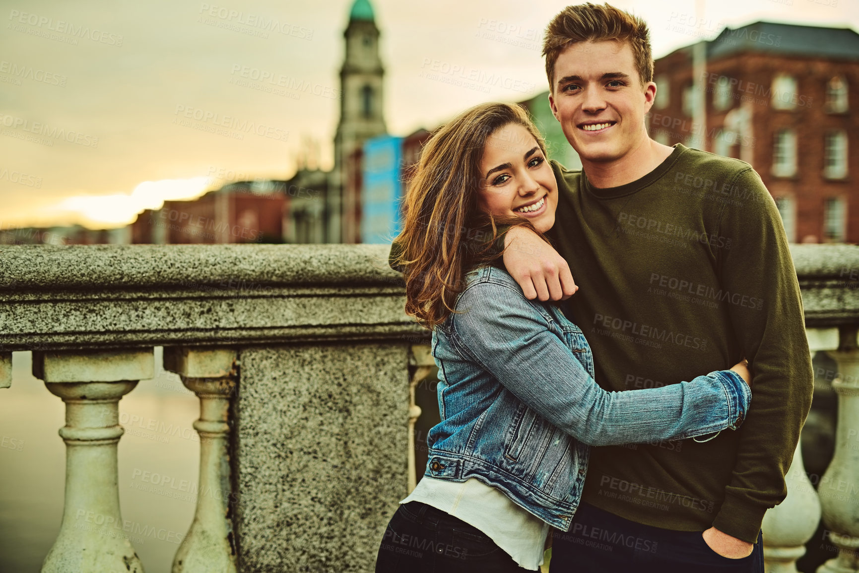 Buy stock photo Happy couple, portrait and hug with love in city for embrace, support or outdoor travel together. Young man, woman or lovers with smile for romantic holiday, trip or getaway on bridge in london