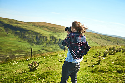 Buy stock photo Shot of a man taking photographs with his camera outdoors