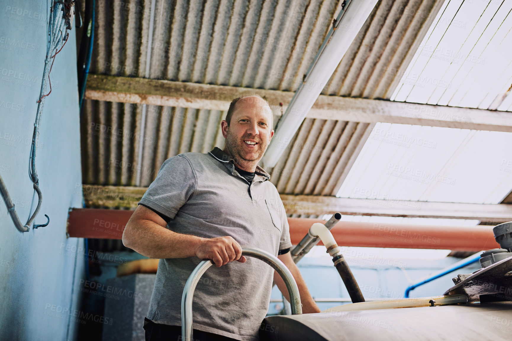 Buy stock photo Man, portrait and farmer with machine, agriculture and container for milk, organic produce and natural. Person, entrepreneur and business owner with happiness, industrial and eco friendly in factory