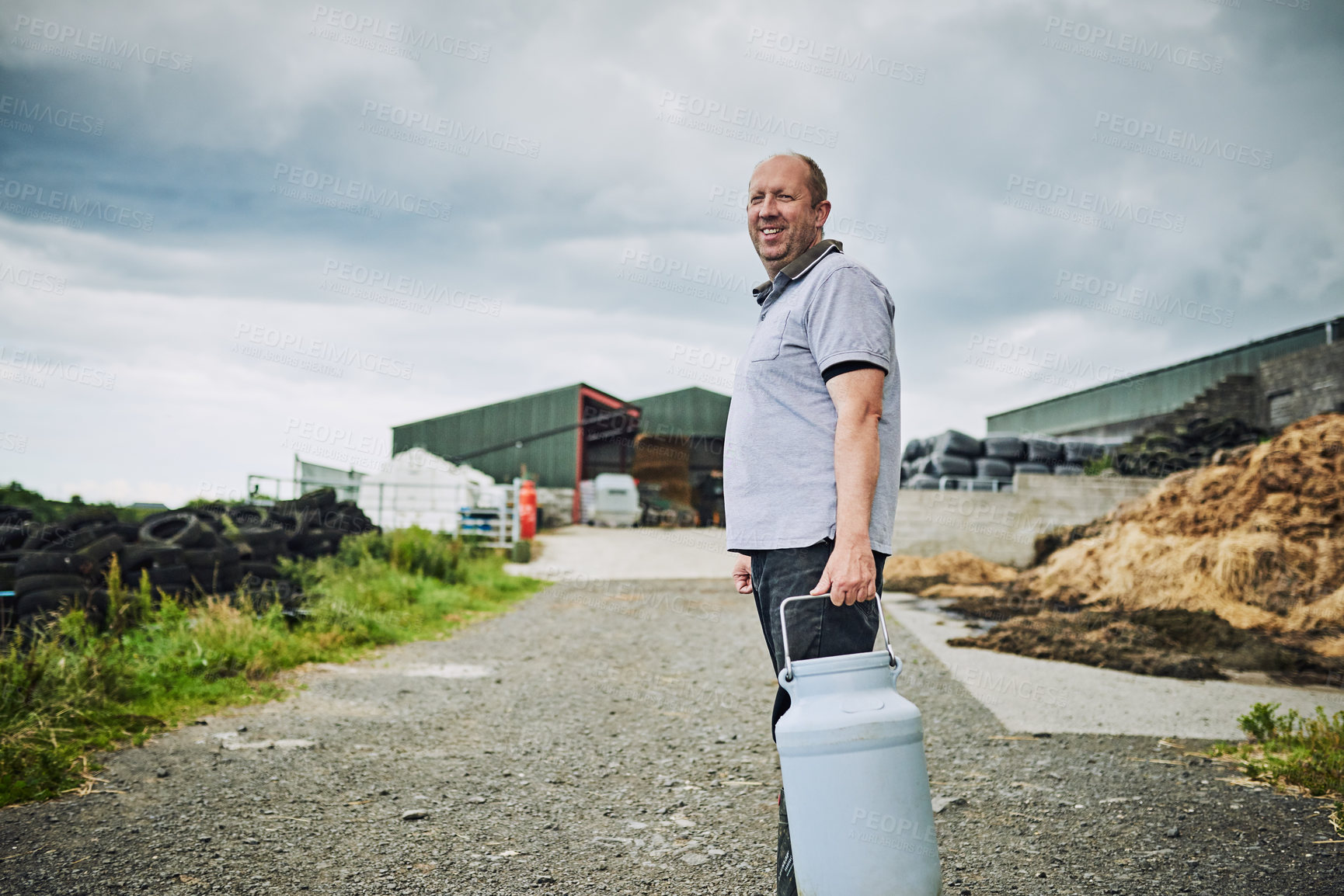 Buy stock photo Farm, portrait and man with bucket for milk production, livestock produce and dairy industry. Agriculture, countryside and person with storage and tank for cattle, sustainable business and factory