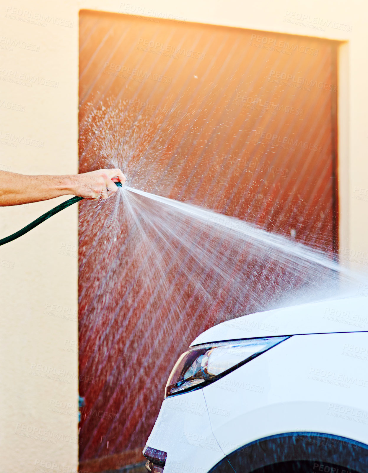 Buy stock photo Cropped shot of an unrecognizable man washing his car outside