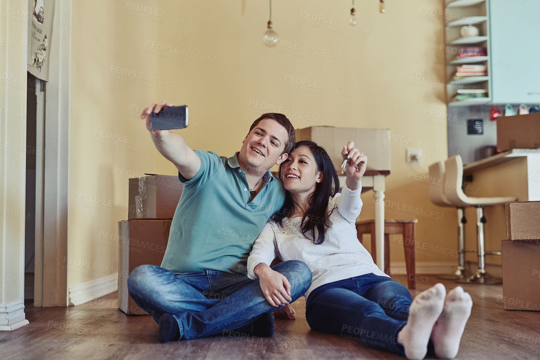 Buy stock photo Happy couple, relax and keys with selfie for new home, apartment or moving in together. Young man, woman or tenant owners with smile for picture, photography or memory on floor with access or boxes