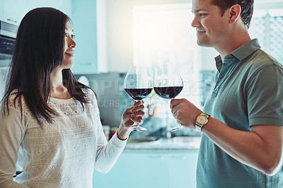 Buy stock photo Cropped shot of a young couple enjoying a glass of wine at home