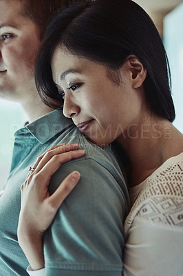 Buy stock photo Cropped shot of an attractive young woman embracing her husband from behind