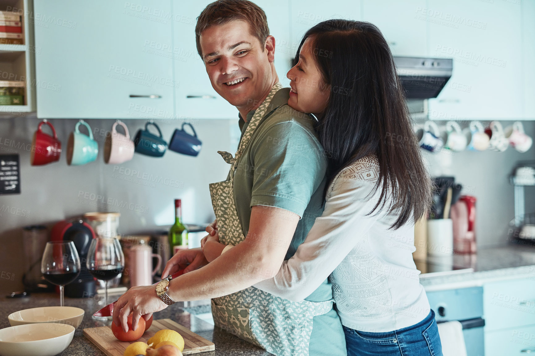Buy stock photo Cropped shot of an affectionate couple standing in the kitchen