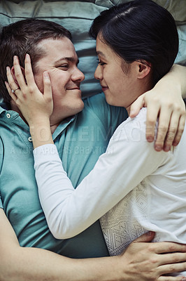 Buy stock photo Cropped shot of a loving young couple relaxing at home