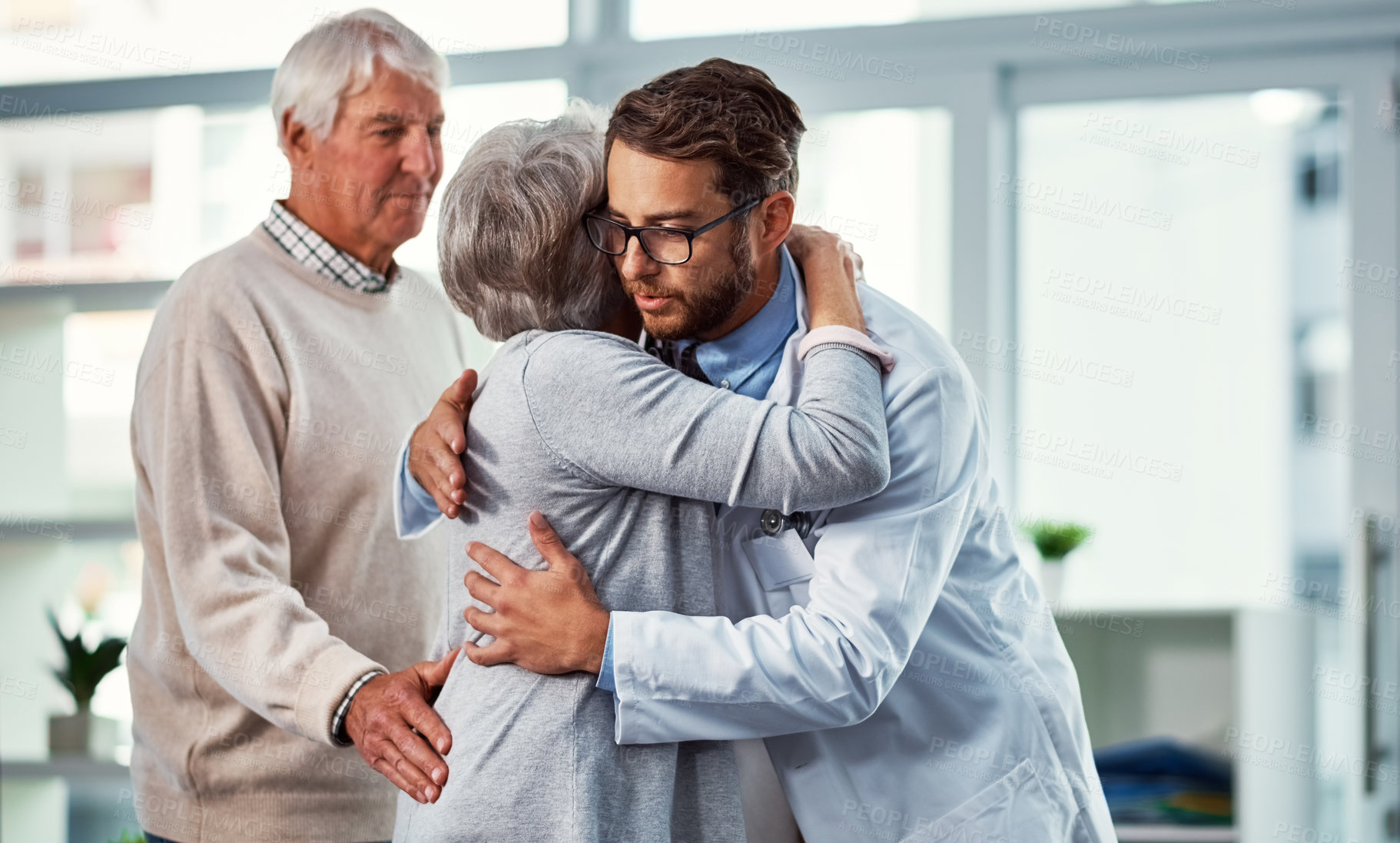 Buy stock photo Hug, comforting and doctor with senior couple for support, compassion and empathy for diagnosis. Healthcare, embrace and elderly man and woman for consulting, medical results and feedback in clinic