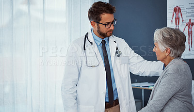 Buy stock photo Shot of a doctor examining a senior patient in a clinic
