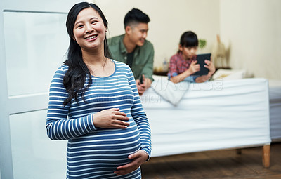 Buy stock photo Portrait of a pregnant woman relaxing with her family at home